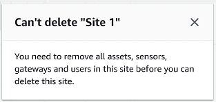 Error message indicating inability to delete "Site 1" due to remaining assets and users.