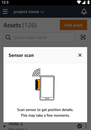 Smartphone icon next to a sensor icon with wireless waves, indicating a scanning process.