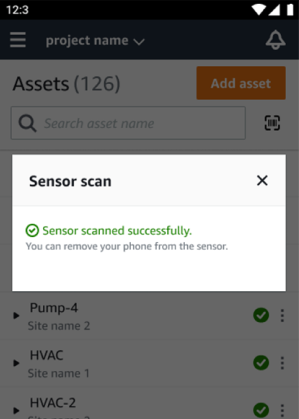 Mobile app interface showing successful sensor scan message with option to remove phone from sensor.