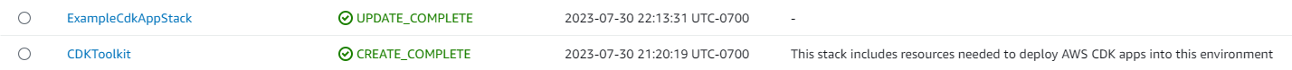 AWS CloudFormation stack showing ExampleCdkAppStack update complete and CDKToolkit creation complete.