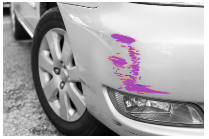 Close-up of a car's front section with purple paint scratches on the white body panel.