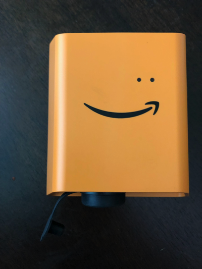 Orange device with Amazon smile logo and two small dots above, representing LEDs.