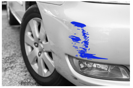 Close-up of a car's front section with a blue scratch mark on the side panel.